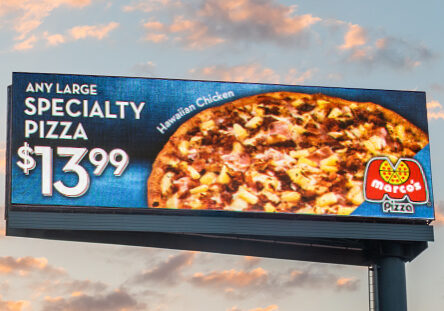 A large specialty pizza sign with hawaiian chicken.