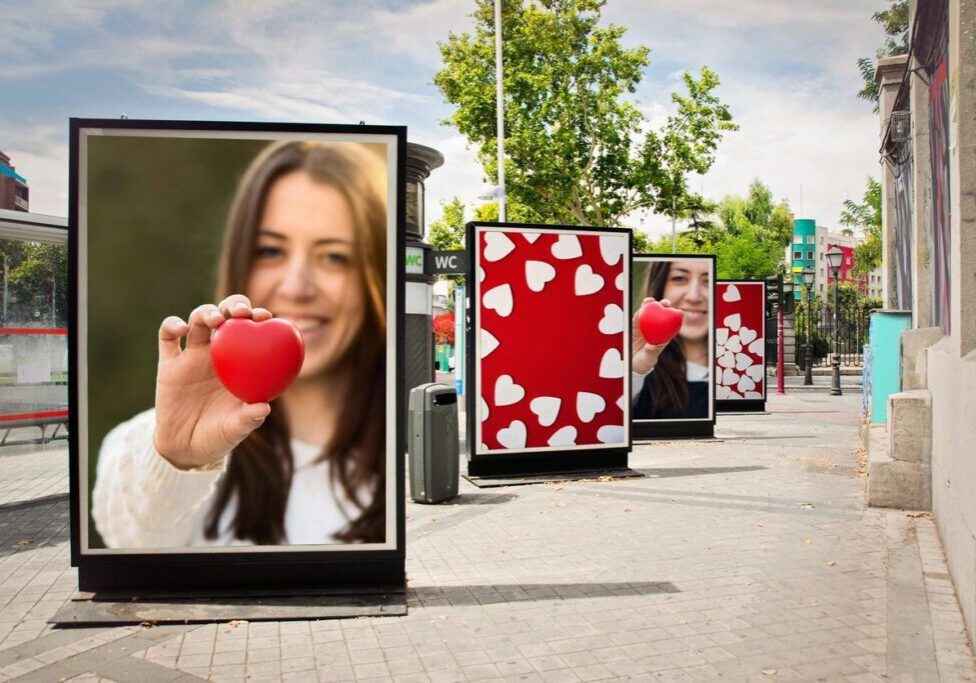 A row of billboards with women holding hearts.